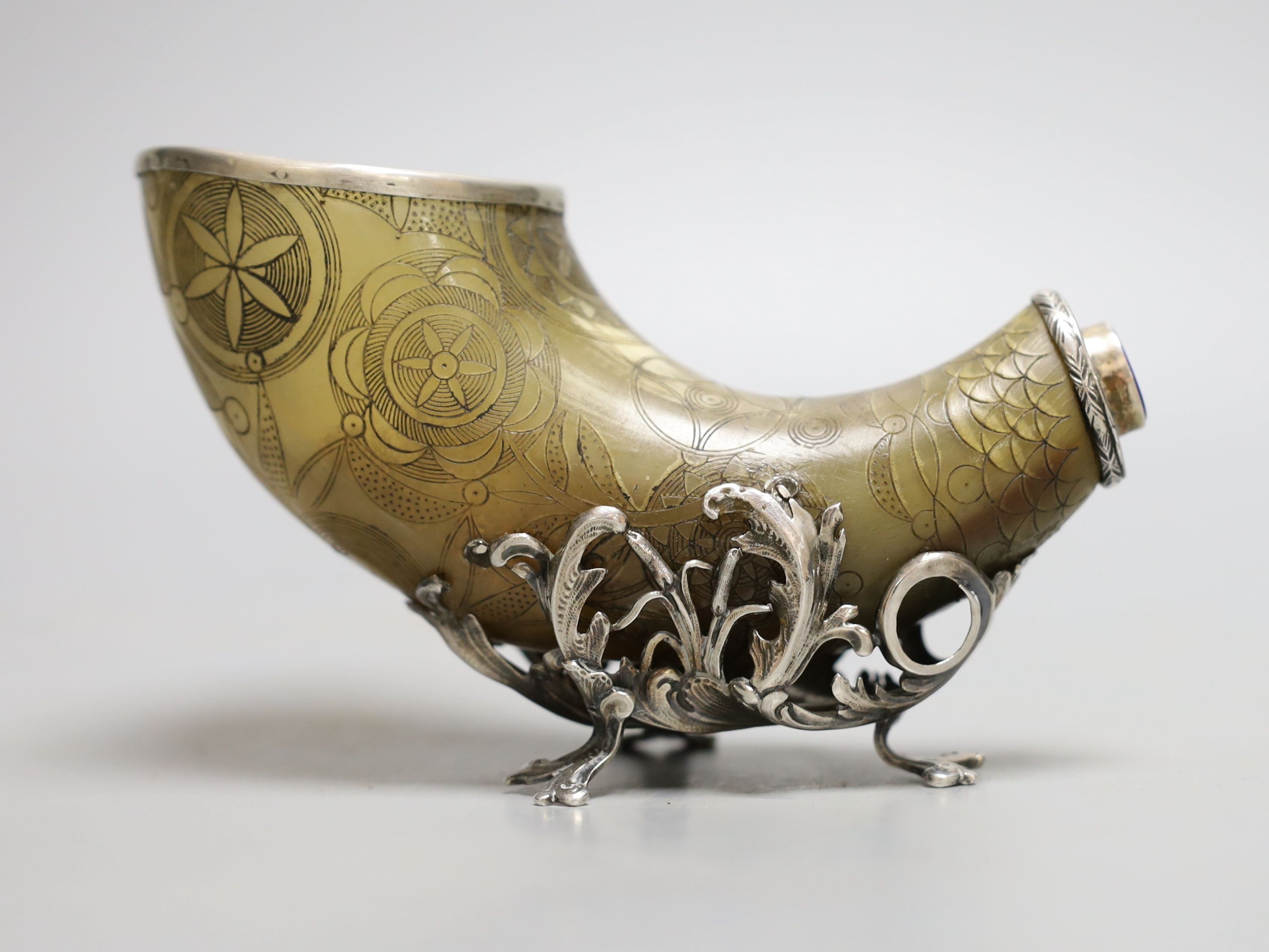 An 18th century, silver mounted decorated horn, with lapis mount, 25 cms wide.